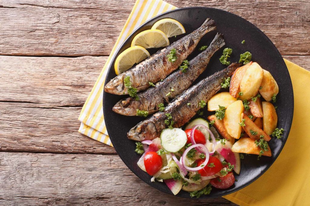 Grilled sardines with roasted potatoes and fresh vegetable salad